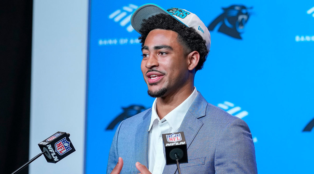 Bryce Young in front of a Panthers backdrop on draft night
